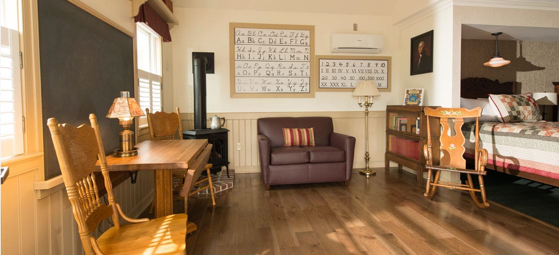 Teacher’s desk, a blackboard, gas stove, books and a globe included in the Schoolhouse Suite at Bird-in-Hand Family Inn