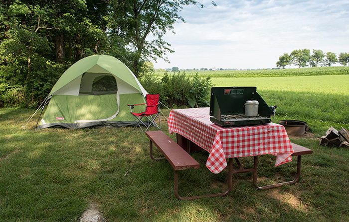 A tent next to a picnic table at Bird-in-Hand Country Acres Campground